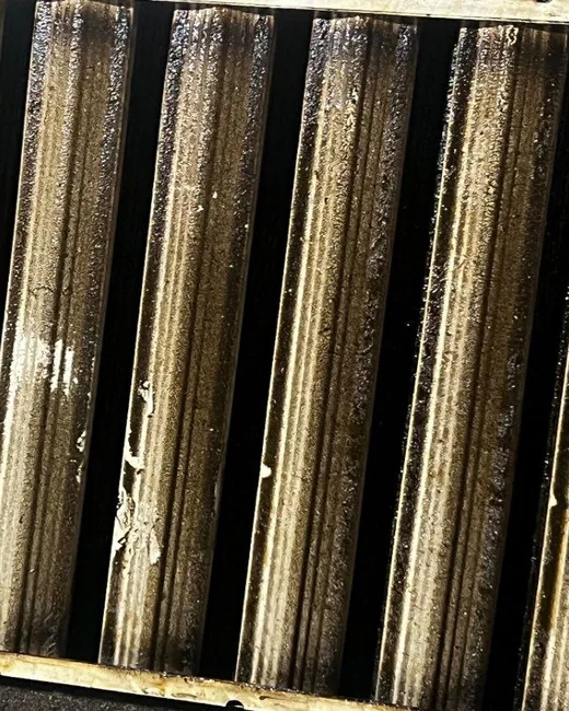 Greasy commercial kitchen hood filters before cleaning