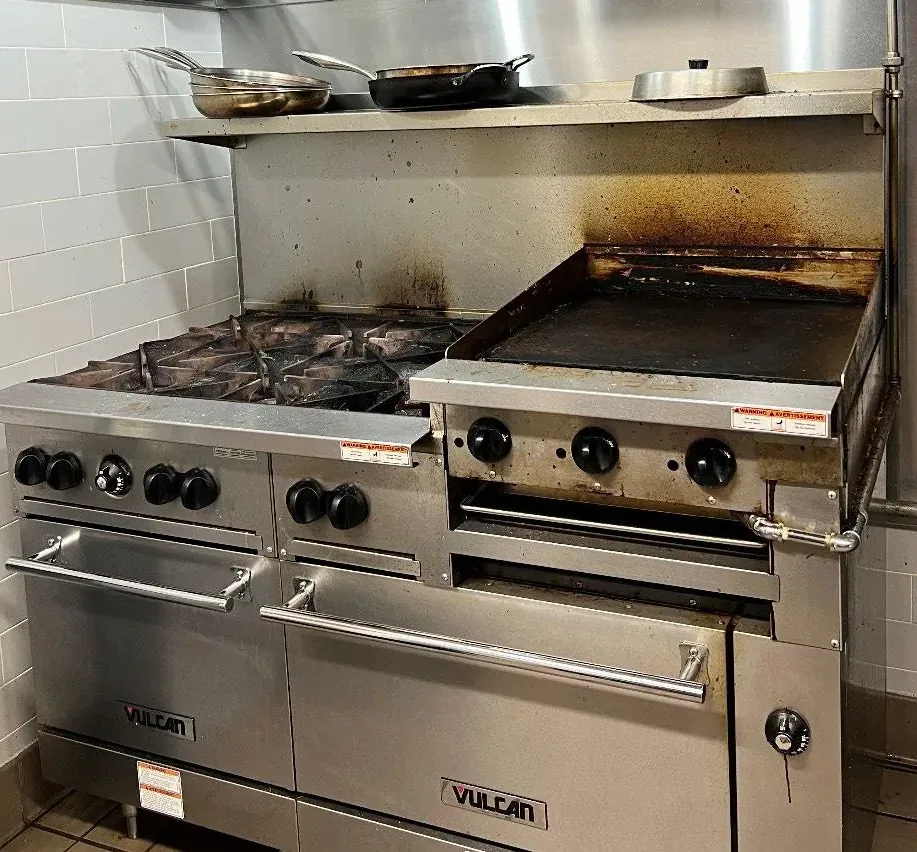 Grease buildup on commercial kitchen equipment before cleaning
