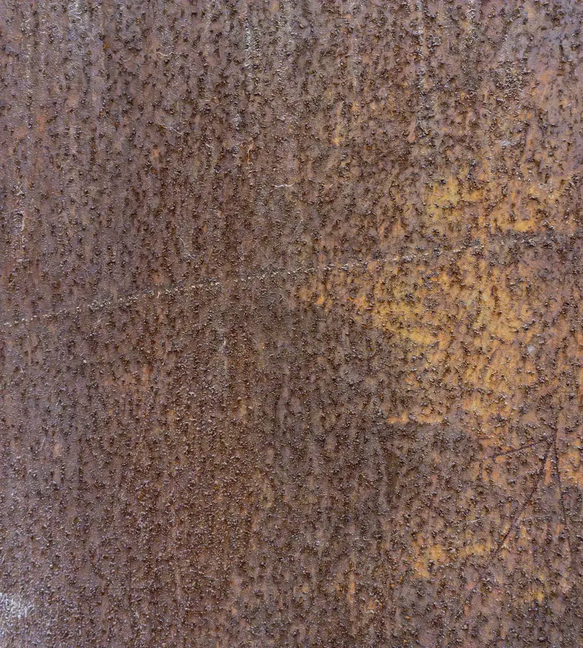 Close-up of pitted, oxidized industrial steel